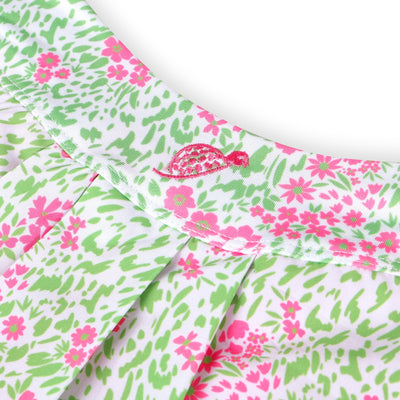 A product image of a pink and green floral golf skort