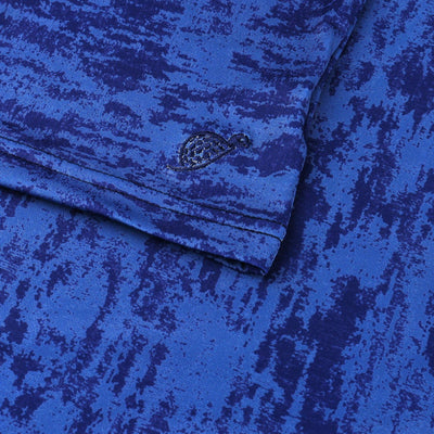 Logo detail of a Turtles and Tees navy blue print polo