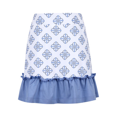 An image of a girls white golf skort with blue and black patterns printed on it and a blue ruffled hem
