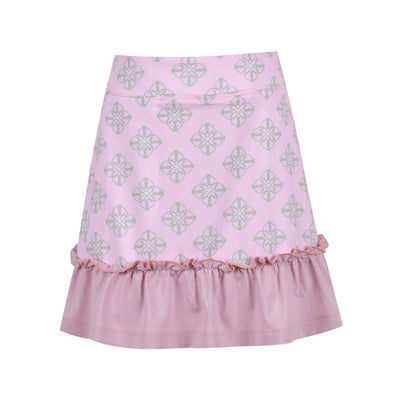 An image of a girl's light pink golf skort with light green printed pattern and a ruffle hem